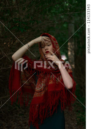 Slavic girl in a scarf pray in forest 114133343