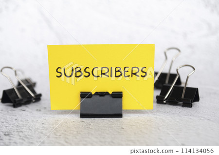 Subscribers text on standing yellow paper. Subscribers text on standing yellow paper. 114134056