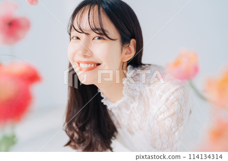 A woman surrounded by flowers 114134314