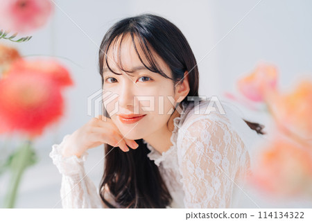 A woman surrounded by flowers 114134322