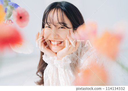 A woman surrounded by flowers A woman surrounded by flowers 114134332