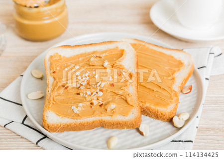 Peanut butter sandwiches or toasts on light table background.Breakfast. Vegetarian food. American cuisine top view vith copy space Peanut butter sandwiches or toasts on light table background.Breakfast. Vegetarian food. American cuisine top view vith copy space 114134425