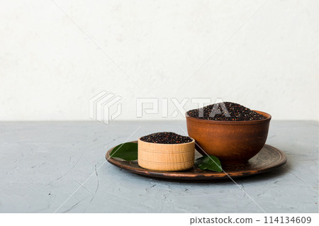 quinoa seeds in bowl on colored background. Healthy kinwa in small bowl. Healthy superfood quinoa seeds in bowl on colored background. Healthy kinwa in small bowl. Healthy superfood 114134609