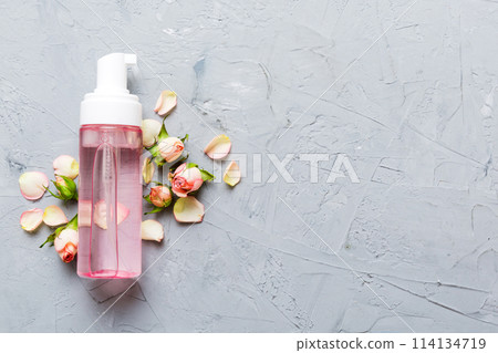 Fancy healthcare bottles for serum, micellar, tonic, toner, lotion, water and cream with rose flower. Natural oranic spa cosmetics concept. Mockup, template, Top view Fancy healthcare bottles for serum, micellar, tonic, toner, lotion, water and cream with rose flower. Natural oranic spa cosmetics concept. Mockup, template, Top view 114134719