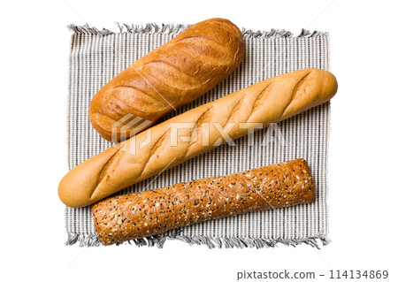 Freshly baked delicious french bread with napkin isolated on white background top view. Healthy white bread loaf Freshly baked delicious french bread with napkin isolated on white background top view. Healthy white bread loaf 114134869