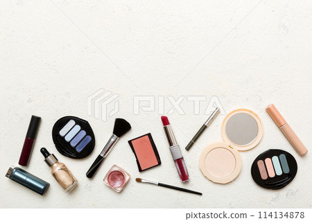 Professional makeup tools. Top view. Flat lay. Beauty, decorative cosmetics. Makeup brushes set and color eyeshadow palette on table background. Minimalistic style 114134878