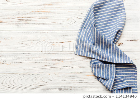 top view with blue kitchen napkin isolated on table background. Folded cloth for mockup with copy space, Flat lay. Minimal style 114134940