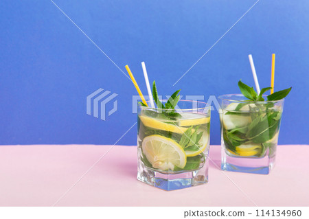 Mojito summer refreshing cocktail with ice and mint. mojito cocktail with lime, lemon and mint in a tall glass with a stick 114134960