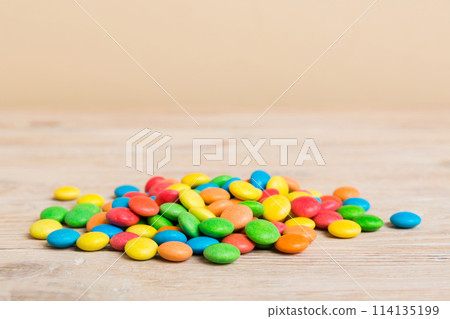 Pile of delicious colorful sweet candies on colored background top view. Confectionery decor 114135199