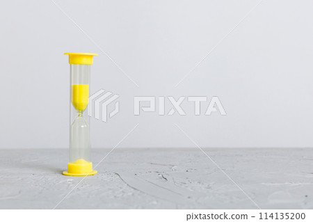 hourglass on the table, sand clock as time passing concept for business deadline, copy space hourglass on the table, sand clock as time passing concept for business deadline, copy space 114135200
