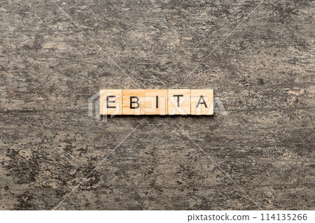 EBITA word written on wood block. EBITA text on cement table for your desing, concept 114135266