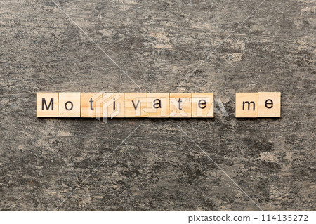 Motivate me word written on wood block. Motivate me text on cement table for your desing, concept 114135272