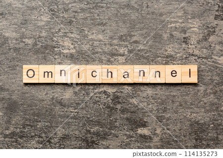 OMNICHANNEL word written on wood block. OMNICHANNEL text on cement table for your desing, concept 114135273