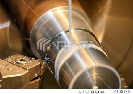 The lathe machine finish cut  metal shaft parts with liquid coolant method. 114136180