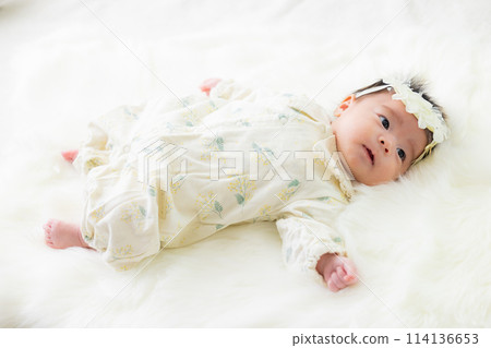 Baby in a baby dress 114136653
