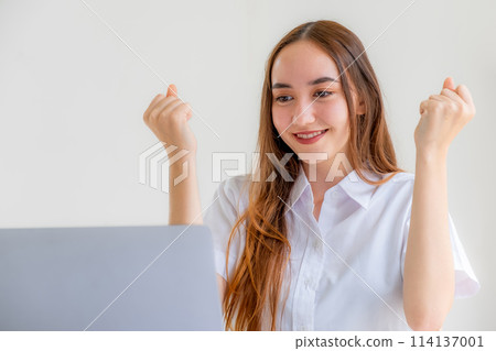 Yes! Caucasian happy businesswoman bookkeeper excited triumphing with raised hands achieve target at home office, Use laptop analysis the graph and Setting challenging business goals Yes! Caucasian happy businesswoman bookkeeper excited triumphing with raised hands achieve target at home office, Use laptop analysis the graph and Setting challenging business goals 114137001