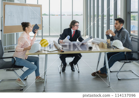 Engineer team meeting to inspect the construction blueprint drawings, work plan and distribute work before starting the building 114137096