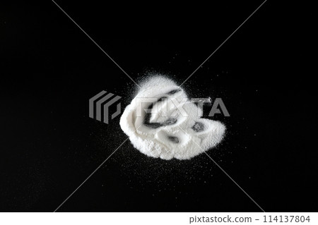 Baking soda on a black background. 114137804