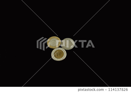 Metal money on a black background. Metal money on a black background. 114137826