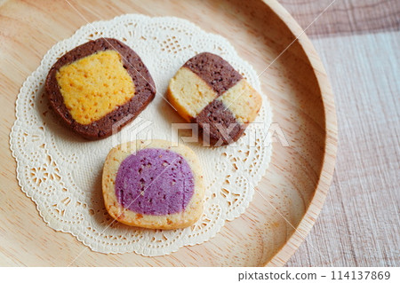 Freshly baked homemade cookies baked with my 10-year-old child. Pumpkin, purple sweet potato, and almond flavored icebox cookies. Freshly baked homemade cookies baked with my 10-year-old child. Pumpkin, purple sweet potato, and almond flavored icebox cookies. 114137869