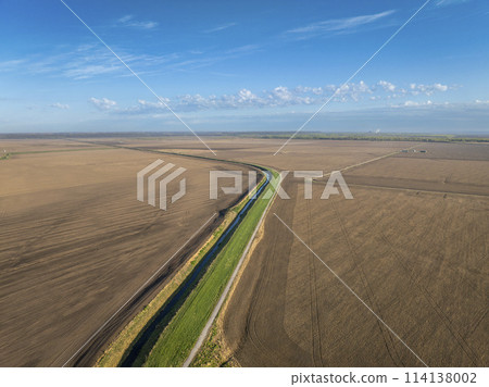 Steamboat Trace, bike trail converted from an abandoned railroad, running through Nebraska farmland near Peru, springtime aerial view 114138002