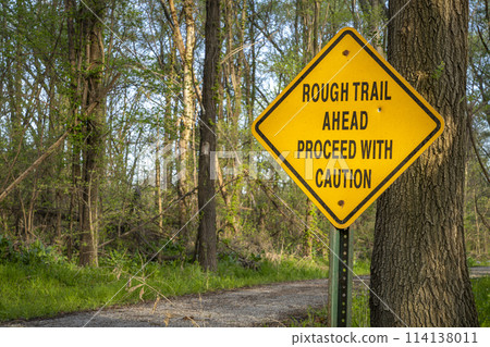 rough trail ahead, proceed with caution - warning sign on Steamboat Trace Trail converted from old railroad near Peru, Nebraska 114138011