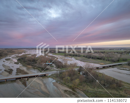 springtime sunrise over Platte River and plains near Kerney, Nebraska 114138072