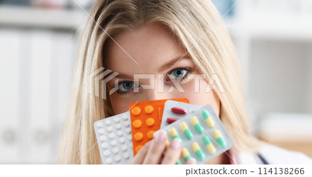 Female doctor hand holding pack of different 114138266
