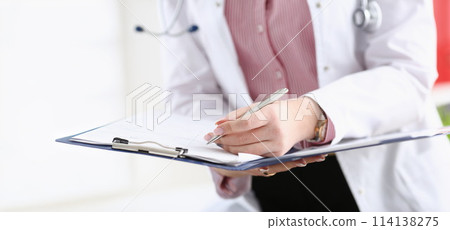 Male doctor arm hold silver pen filling patient 114138275