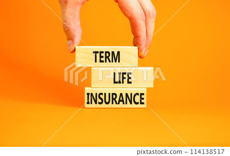 Term life insurance symbol. Concept words Term life insurance on beautiful wooden blocks. Beautiful orange table orange background. Doctor hand. Medical term life insurance concept. Copy space. 114138517