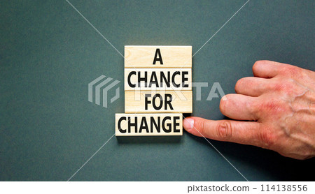 A chance for change symbol. Concept words A chance for change on beautiful wooden block. Beautiful grey table grey background. Voter hand. Business A chance for change concept. Copy space. 114138556
