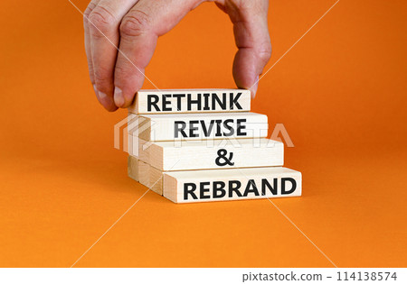 Rethink revise rebrand symbol. Concept word Rethink Revise and Rebrand on beautiful block. Beautiful orange background. Business brand motivational rethink revise rebrand concept. Copy space. 114138574