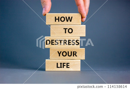 Destress your life symbol. Concept words How to destress your life on wooden blocks. Doctor hand. Beautiful grey background. Psychological business and destress your life concept. Copy space. 114138614