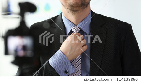 Male arm in blue suit set tie closeup on Male arm in blue suit set tie closeup on 114138866