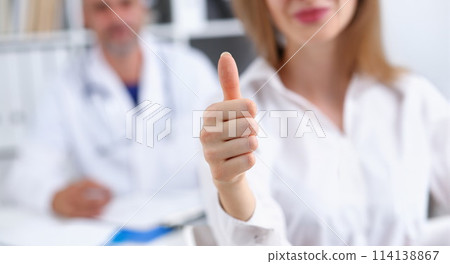 Arm show ok or confirm with thumb up at 114138867