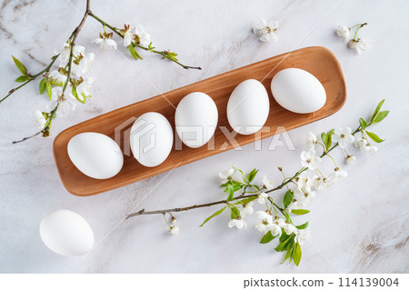 Concept of spring, eggs with flowers, top view 114139004