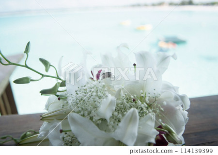 Bridal Bouquet with Wedding Ring and Ocean Backdrop Bridal Bouquet with Wedding Ring and Ocean Backdrop 114139399