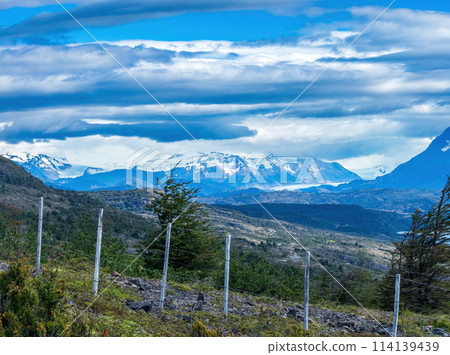 Majestic Mountain Ranges Under a Dramatic Cloudy Sky Majestic Mountain Ranges Under a Dramatic Cloudy Sky 114139439