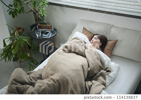 Women in their twenties sleeping in bed 114139837