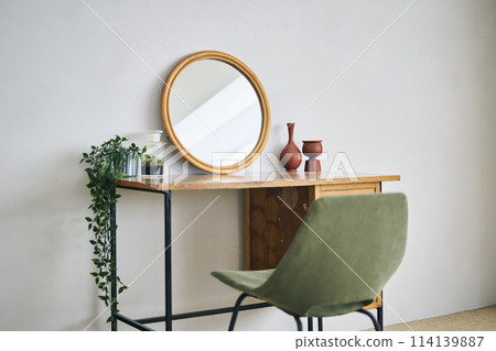 A room with a dresser and potted plants A room with a dresser and potted plants 114139887