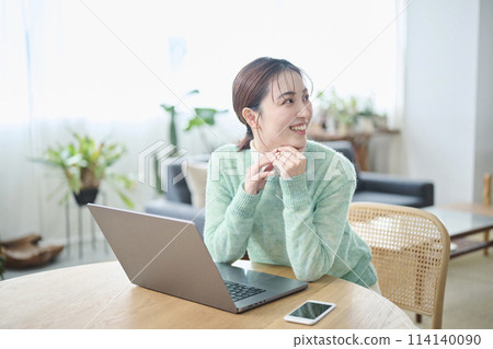 Women in their 20s chatting while working on a computer Women in their 20s chatting while working on a computer 114140090