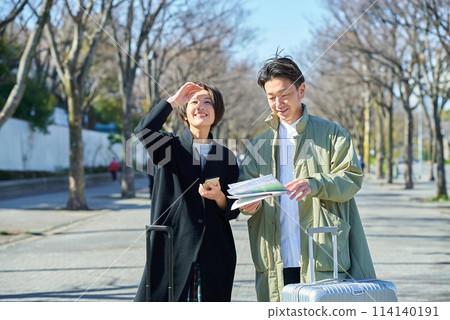 Man and woman lost with suitcases Man and woman lost with suitcases 114140191