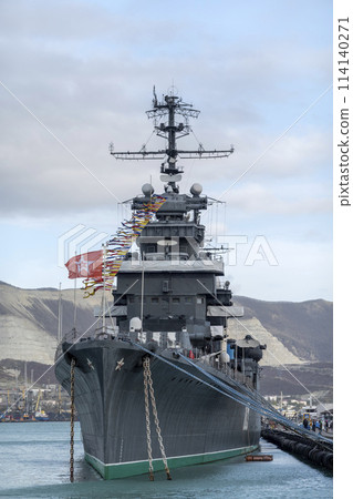 Novorossiysk, Russia - 18 August 2023. Cruiser Mikhail Kutuzov and dolphins, Black Sea, port, Krasnodar Territory, Novorossiysk. Novorossiysk, Russia - 18 August 2023. Cruiser Mikhail Kutuzov and dolphins, Black Sea, port, Krasnodar Territory, Novorossiysk. 114140271