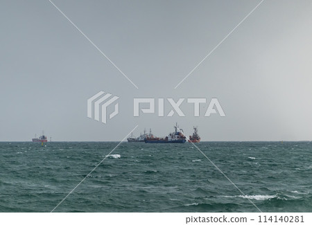 Sea freighter sailing in the middle of the ocean with big waves. Sea freighter sailing in the middle of the ocean with big waves. 114140281
