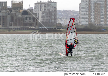 A kite surfer rides and jumps the waves the black sea 114140304
