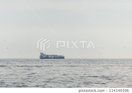Sea freighter sailing in the middle of the ocean with big waves. Sea freighter sailing in the middle of the ocean with big waves. 114140306