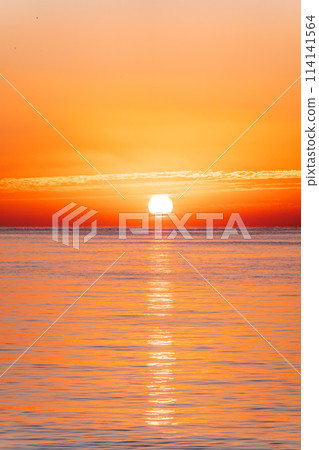 Beautiful red and orange sunrise over the sea. Beautiful red and orange sunrise over the sea. 114141564