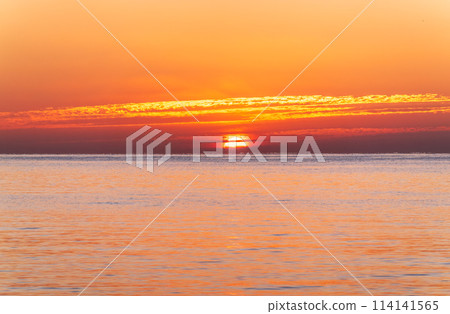 Beautiful red and orange sunrise over the sea. Beautiful red and orange sunrise over the sea. 114141565