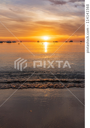 Beautiful red and orange sunrise over the sea. Beautiful red and orange sunrise over the sea. 114141568