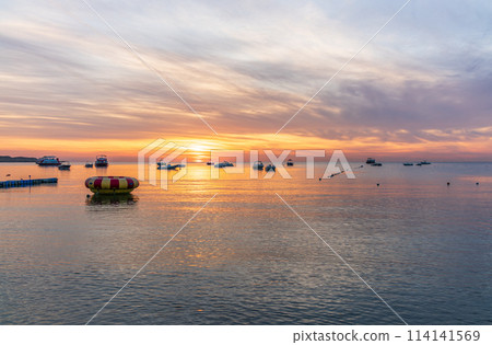 Beautiful red and orange sunrise over the sea. Beautiful red and orange sunrise over the sea. 114141569